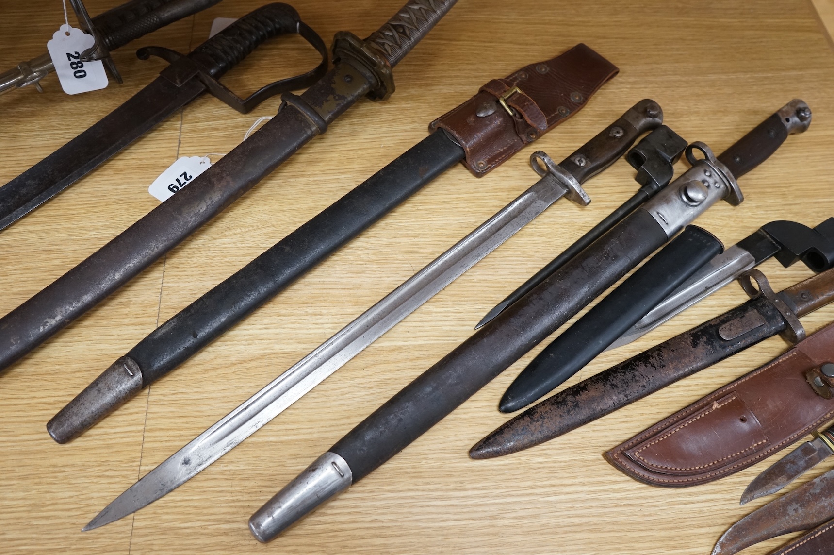 A 1907 bayonet by Wilkinson in its steel mounted leather scabbard, another similar with leather frog, two small British bayonets, a Continental bayonet, and two assorted hunting knives (7)